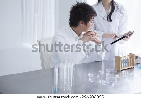 Science student holding tablet pc in lab at the university