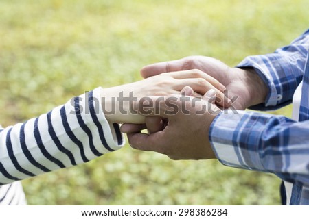 Two pairs of hand touch each other, together, helping hands