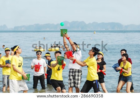 16 June 2014 in Halong bay Vietnam, unknown name staff of Mobile World JSC play team building game at sea side. Mobile World JSC is a big group retailers of electronics in Vietnam