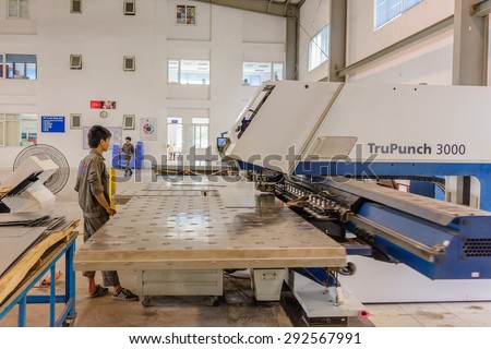 21 June 2015 in Hanoi Vietnam, Branch Trump CNC sew machine working in factory, man worker