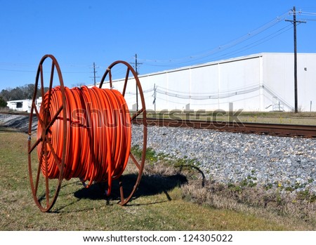 Industrial Cable On A Metal Reel Next To Train Tracks