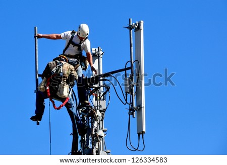 Two Technicians Working On A Telecommunication Tower