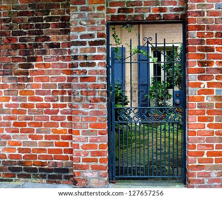 Brick Wall With Gate To Courtyard In New Orleans French Quarter