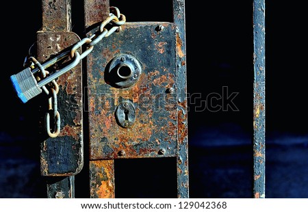 Closeup Of Old Iron Gate Locked With Padlock And Chain