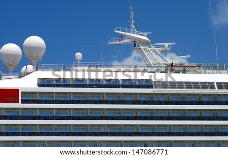 Exterior side view of a cruise ship showing ocean front rooms and navionics.