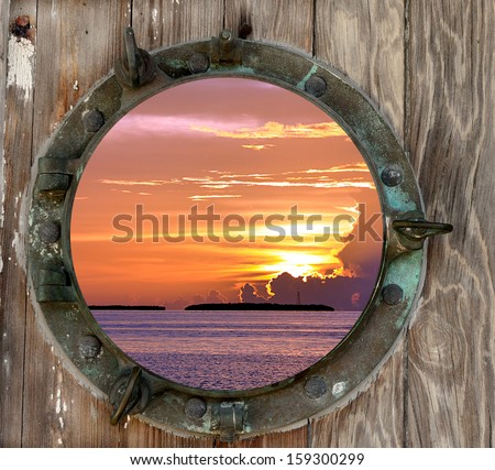 View of a beautiful Key West, Florida sunset, as seen through a old rustic porthole.