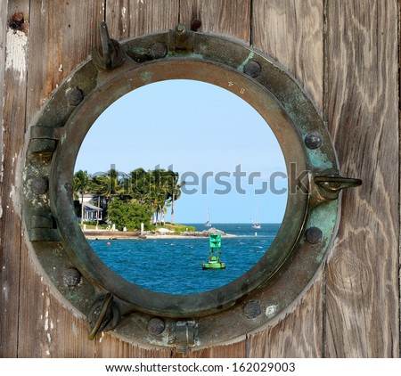 Sunset Key, Key West, Florida, as seen through a rustic old porthole.