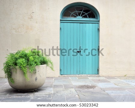 Shuttered Door With Planter In New Orleans French Quarter