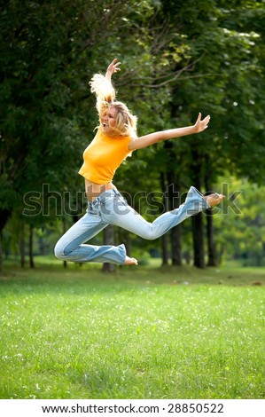 Wow jump of funny lovely woman outdoors