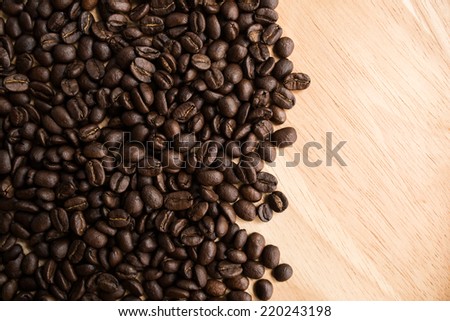 Roasted coffee beans on wood dish