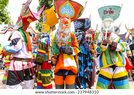 Loei, Thailand - June 23, 2012 : People are dressing with colorful clothes and put the hand made mask which made from wood or threshing bamboo in ghost mask festival or \