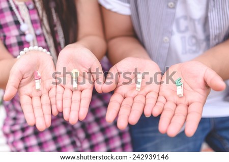 Two open hands show wooden letters of love