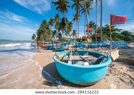 Vietnamese fishing coracles on beach, tribal boats at fishing village
