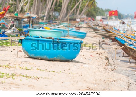 Vietnamese fishing coracles on beach, tribal boats at fishing village