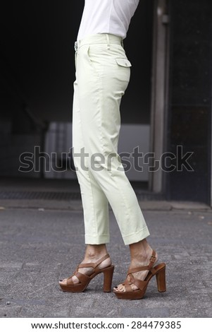 woman in white trousers, white clam diggers, brown high heels, nice legs