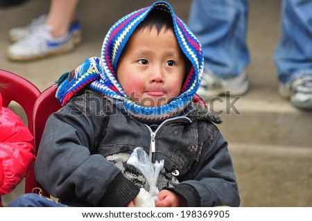 HA GIANG, VIETNAM - FEBRUARY 19: Hmong unidentified boy on the market-day on February 19, 2012 in Hagiang, Vietnam. Hmong people are known for their indigo-dyed costumes and ornate silver jewellery