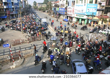 HA NOI, VIET NAM - March 27, 2014: Traffic in Hanoi, Vietnam - Dense, crowed scene of city traffic in rush hour, crowd of people wear helmet, transport by motorcycle in stress situation in morning.