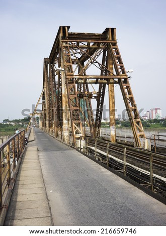 Ha Noi, Viet Nam - September 7, 2014: Old railway bridge and vehicle traffic moving on the old railway bridge in Vietnam