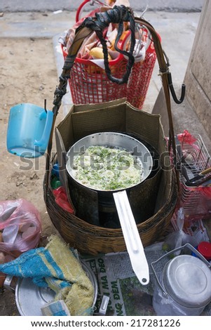 Ha Noi, Viet Nam - September 7, 2014: Fried egg in pan with a basket at street in Hanoi, Vietnam.