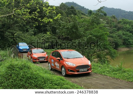 Ninh Binh, Viet Nam April 16, 2014: Ford Fiesta Eco Boost 1.0L car on the road in forest in Vietnam