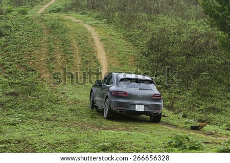 Hoa Binh, Viet Nam - March 27, 2015: Porsche Macan 2015 car running on the mountain in Vietnam