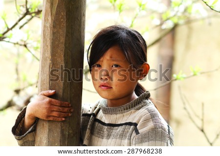 Ha Giang, Viet Nam - Feb 26, 2015: Unidentified girl of Hmong ethnic minority tribe in Viet Nam. Hmong people are known for their indigo-dyed costumes and ornate silver jewellery.
