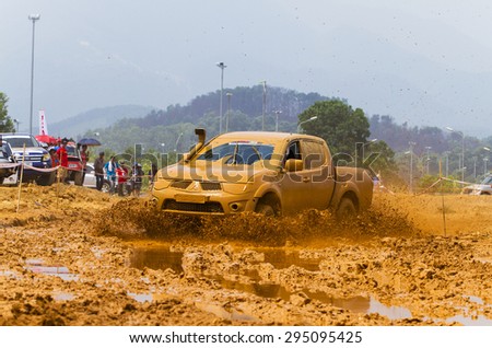 Hanoi, Vietnam - July 4, 2015: Mitsubishi Triton pick-up car doing an circuit of Vietnam Off-road Cup (VOC) in a water road area of Hanoi