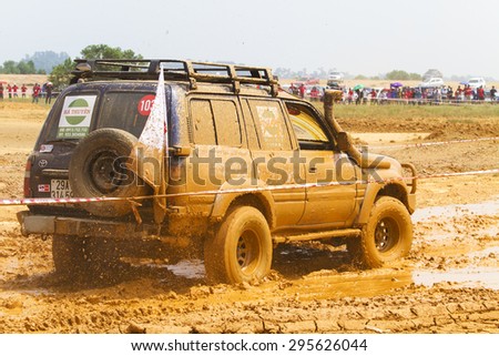 Hanoi, Vietnam - July 4, 2015: Toyota Land Cruiser car doing an circuit of Vietnam Off-road Cup (VOC) in a water road area of Hanoi. VOC is an yearly event for off-road player in Vietnam.