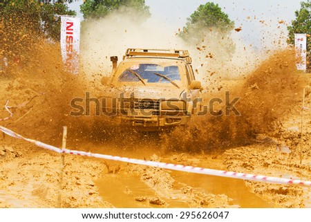 Hanoi, Vietnam - July 4, 2015: Toyota Land Cruiser car doing an circuit of Vietnam Off-road Cup (VOC) in a water road area of Hanoi. VOC is an yearly event for off-road player in Vietnam.