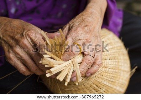 The woman\'s hand to make bamboo fish trap from bamboo material, clever hand and hard working to make product in Vietnam.