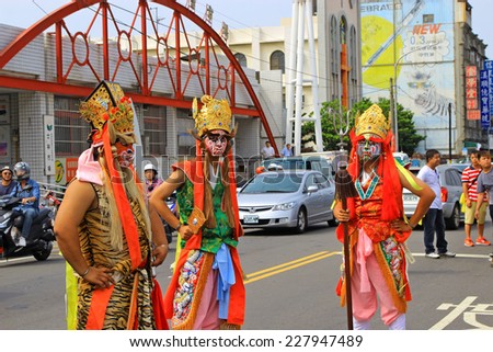 Taiwan's Hsinchu - October 26, 2014: Three young men face painting masks and dressed as ancient warriors ceremony at a local temple.
