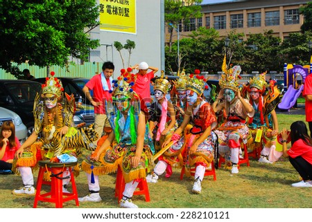 Taiwan\'s Hsinchu - October 26, 2014: eight young men face painting masks, dressed as an ancient temple in the local warrior ceremony.