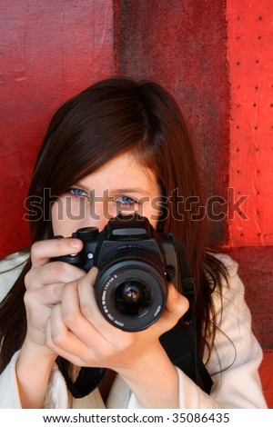 Young pretty girl about to take a photograph
