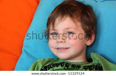 Cute five year old white boy on bright background