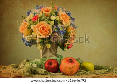 Still life with flowers and fruits on wooden table