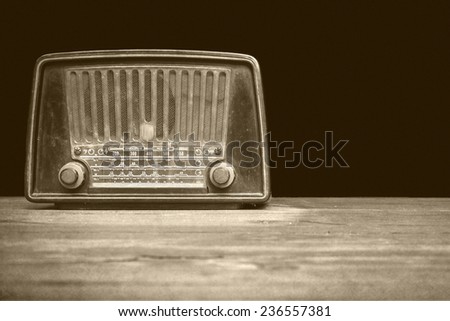 still life with retro radio on the floor on black background
