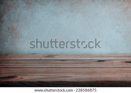 wooden table over wall grunge background