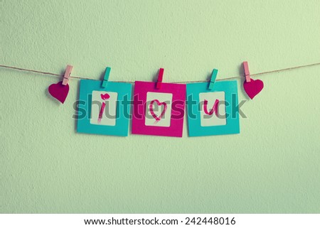 Vintage i love you write on paper photo frame and red heart over wall background, Valentine concept