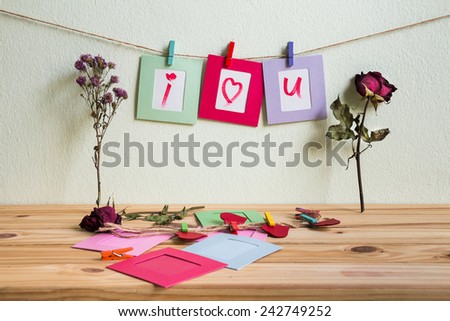 Vintage i love you write on paper paper photo frame on clothesline over grunge background, Valentine concept