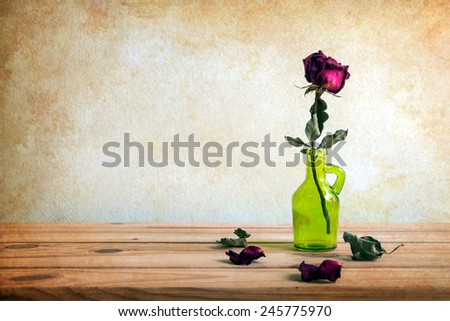 Still life with red rose on wooden table over grunge background, Valentine concept