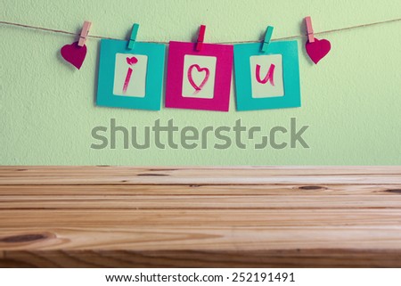 wooden table over vintage i love you write on paper photo frame and red heart over wall background, Valentine concept