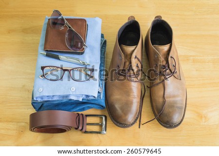 Still life with men\'s casual outfits on wooden background