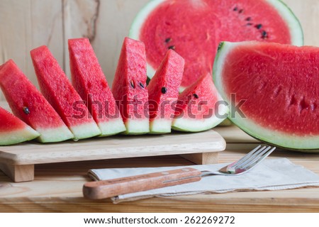 Watermelon on wooden table over grunge background