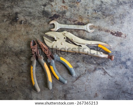Still life with old pliers and locking plier on on table grunge background, top view