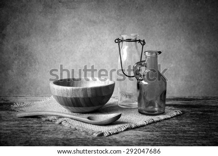 wooden bowl on wooden table over grunge background, rustic style, Black and white
