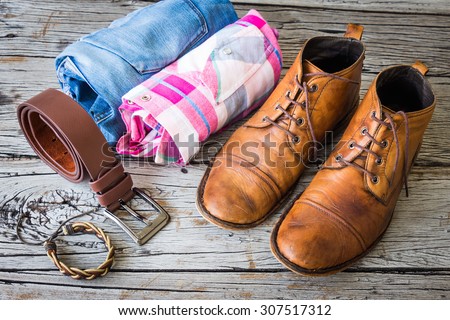 Men\'s casual outfits on wooden background