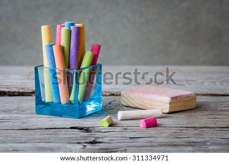 Colored chalks on wooden table, still life