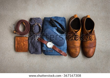 Men's casual outfits with accessories on gray grunge background