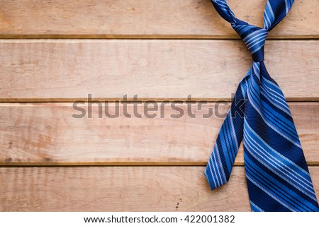 Father's day background with blue necktie on rustic wooden background