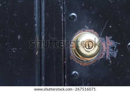 Rusty door knob on black door
